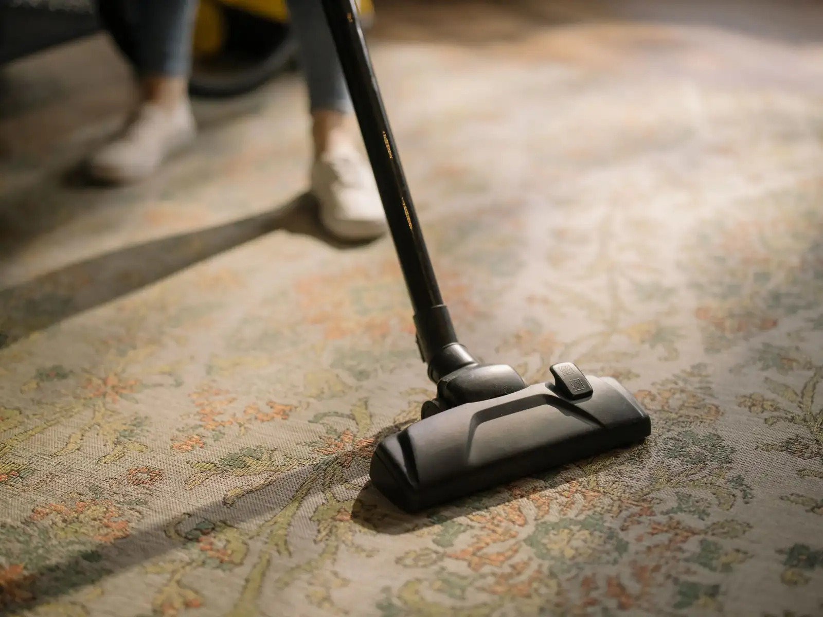 Carpet vacuuming | Carpet cleaning in Heaton Close-up of a vacuum head lifting dirt from a carpet before cleaning, carpet cleaning in Heaton