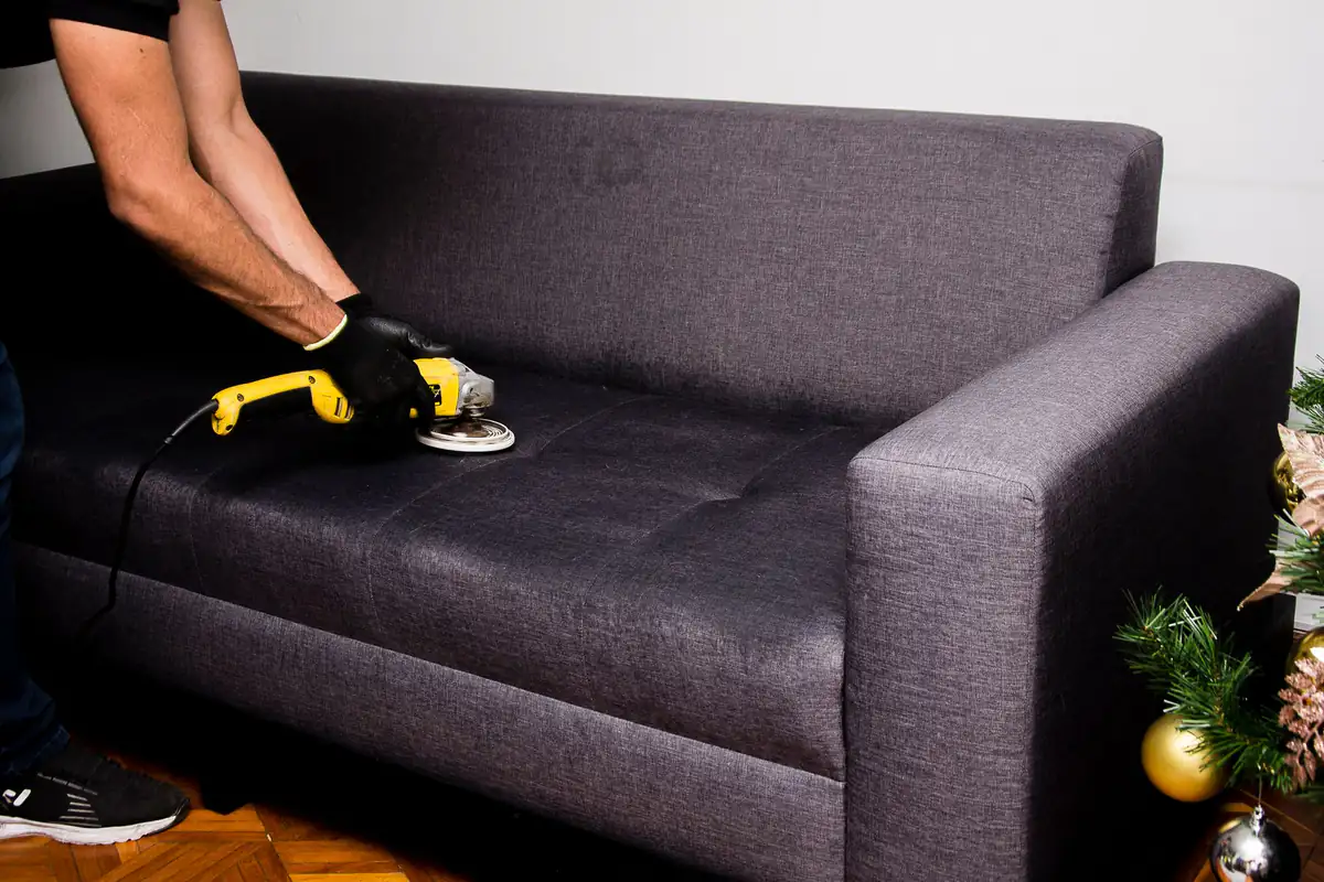 Fabric sofa cleaning | Newcastle Carpet Cleaning Professional cleaning a dark fabric sofa, Newcastle Carpet Cleaning