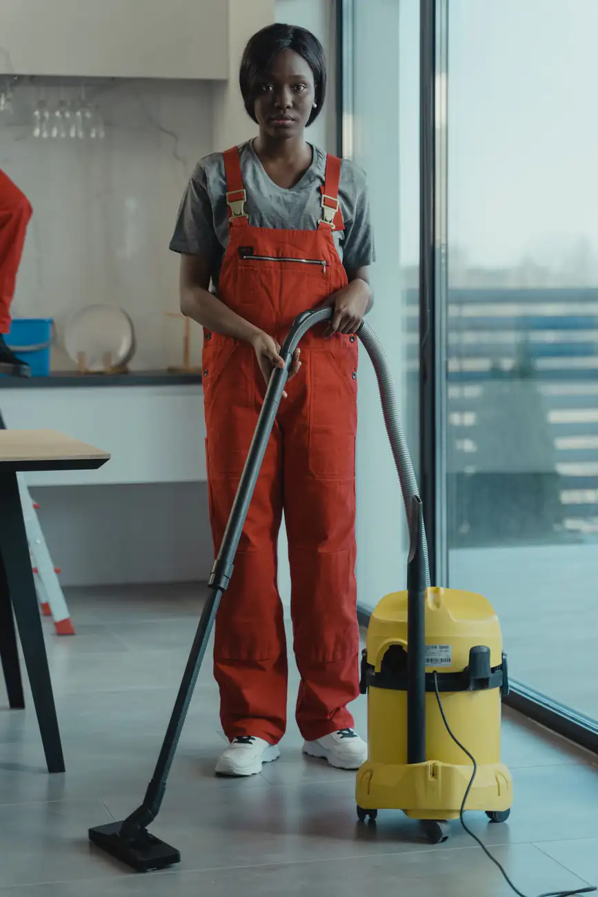 Carpet vacuuming | Commercial carpet cleaning in Newcastle Cleaner vacuuming carpet in a modern open-plan office, commercial carpet cleaning in Newcastle