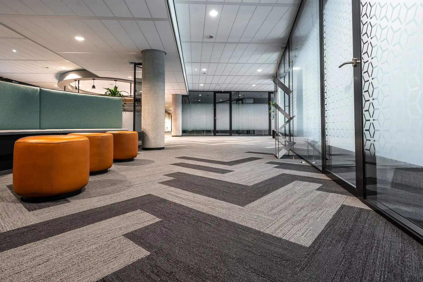 Office carpet tiles | Commercial carpet cleaning in Newcastle Long office corridor with grey commercial carpet and glass-walled rooms, commercial carpet cleaning in Newcastle