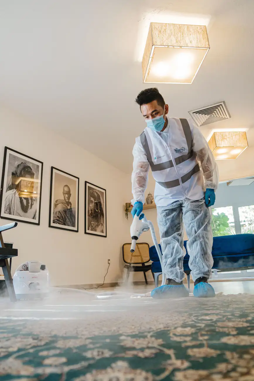 Carpet treatment | Professional carpet cleaning in Newcastle Person in protective gloves treating a carpet, professional carpet cleaning in Newcastle
